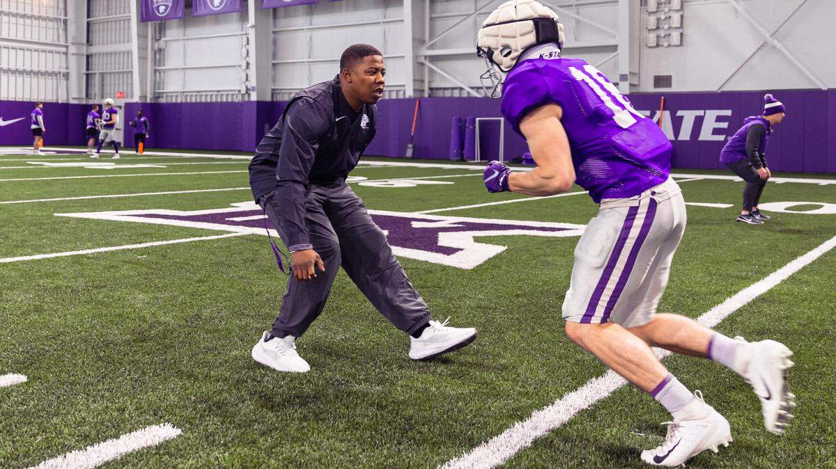 Kansas State wide receivers coach Matthew Middleton helps run drills at a practice in Manhattan.