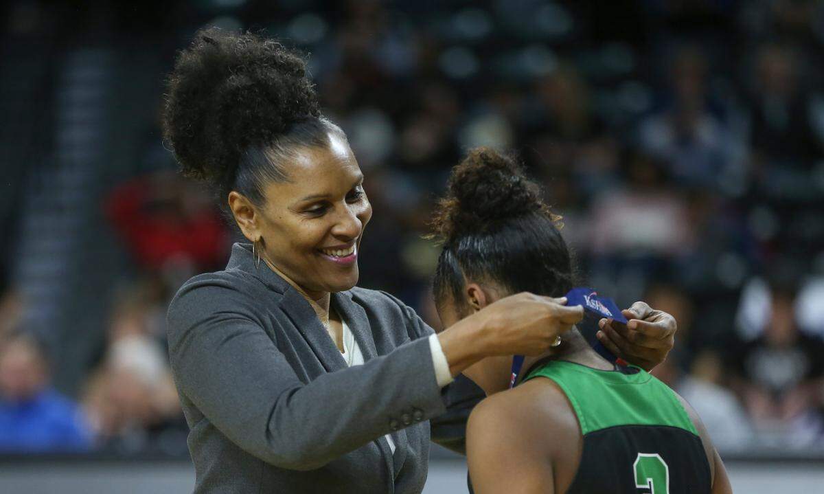 Lynette Woodard places a second place medal on a player from Derby after the 6A Championship game on Saturday at Koch Arena. Woodard played basketball at North High before become a basketball sensation at KU and then joining the Harlem Globetrotters. She’s been enshrined in the Basketball Hall of Fame and is widely considered one of the greatest female players of all time.