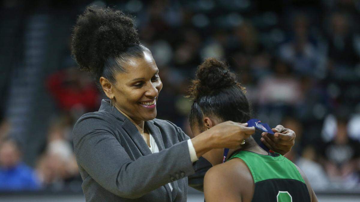 Lynette Woodard places a second-place medal on a player from Derby after the 2022 6A Championship game at Koch Arena. Woodard played basketball at North High before becoming a basketball sensation at KU and then joining the Harlem Globetrotters. She’s been enshrined in the Basketball Hall of Fame and is widely considered one of the greatest female players of all time.