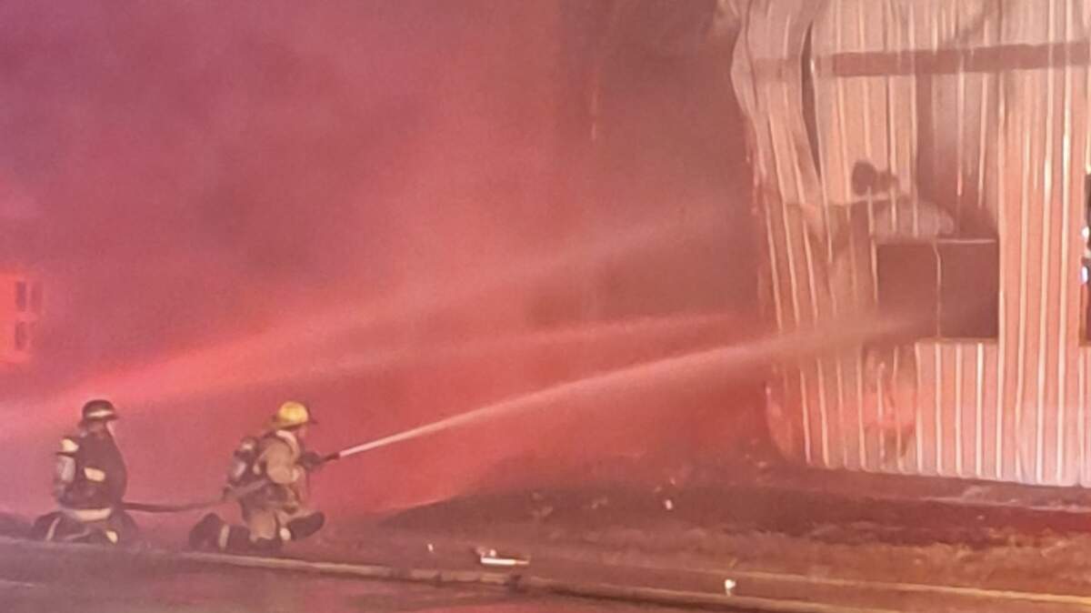 Firefighters battle a Friday-night blaze that destroyed Walnut River Brewing Company’s storage facility in El Dorado.