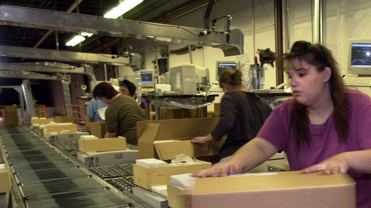 An employee moves an order to a conveyor for shipment at the Dean & DeLuca facility in Wichita in 2000.