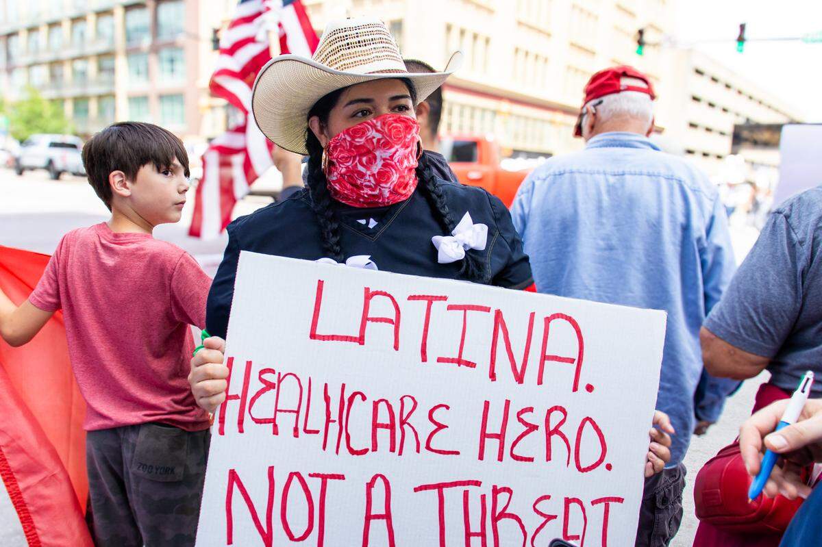 Elizabeth, a single mother of two, protests on Saturday.