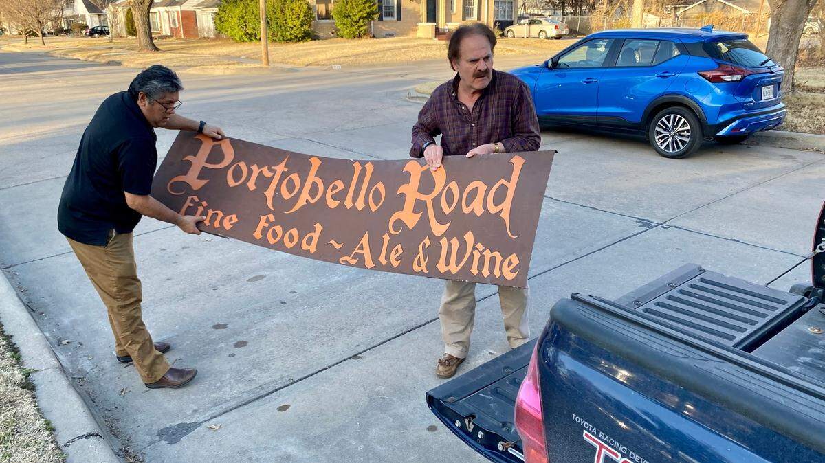 David Perez, left, and Greg Kite load up the old Portobello Road restaurant sign, which Kite snagged at a Wichita estate sale for the Historic Preservation Alliance of Wichita and Sedgwick County.