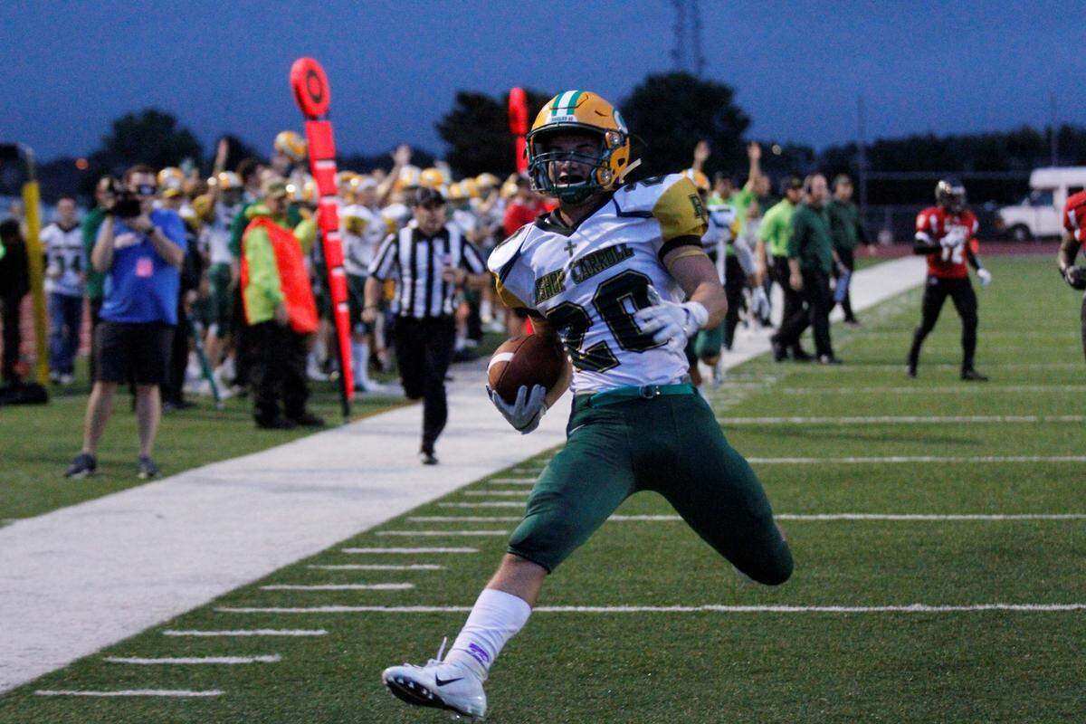 Jackson Nichols, a Bishop Carroll senior running back, high-steps into the end zone as part of his three-touchdown night over Wichita Heights in the Golden Eagles’ 36-20 win over the Falcons on Friday. (Sept. 7, 2018)