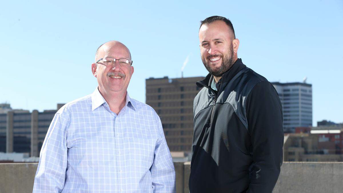 Wichita Eagle editor Michael Roehrman, left, and publisher Tony Berg, right.