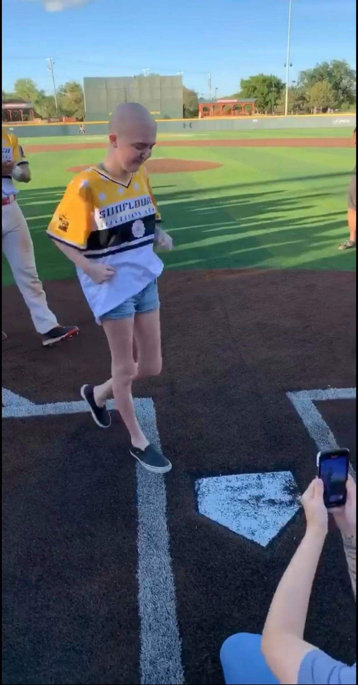 Jessica Kilpatric walks across home plate on Saturday night before the Sunflower Collegiate League all-star game at Eck Stadium. Kilpatric, a 15-year-old Campus sophomore battling neuroblastoma, was an honorary captain.