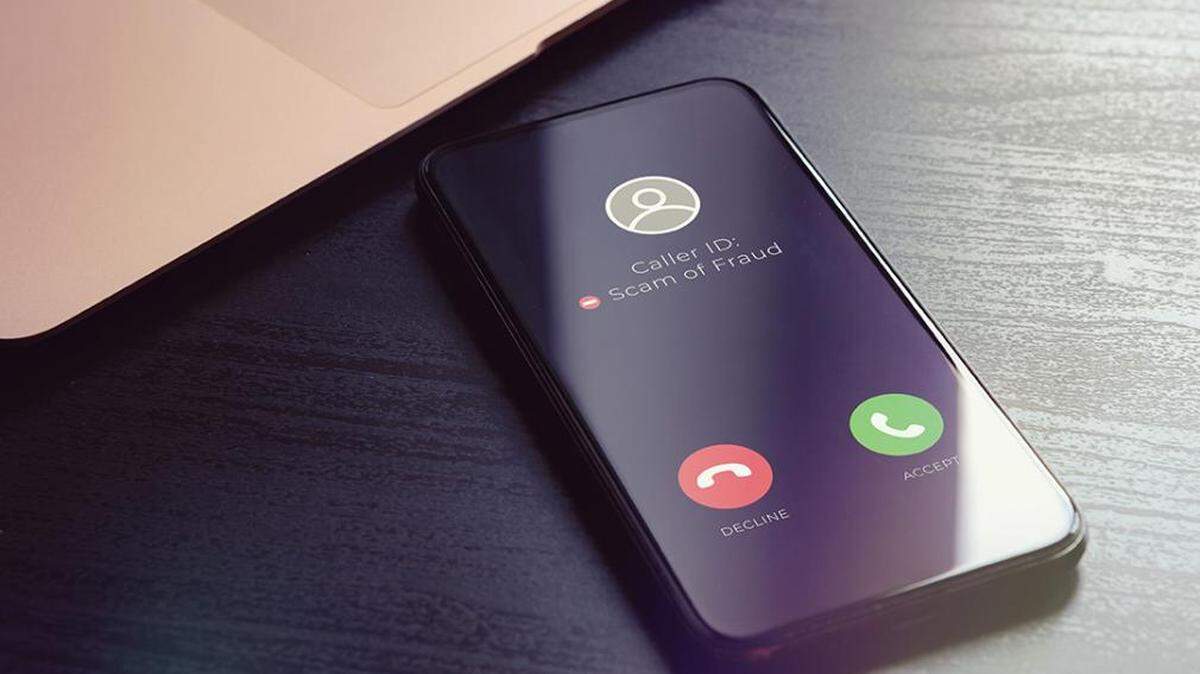 Photo illustration of scam caller on cellphone