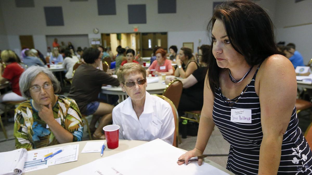 Carrie Philbrick, a software specialist with the Wichita School District, right, makes a point during a forum about pay inequity and other issues at a forum Thursday at Pleasant Valley United Methodist Church. (June 28, 2018)