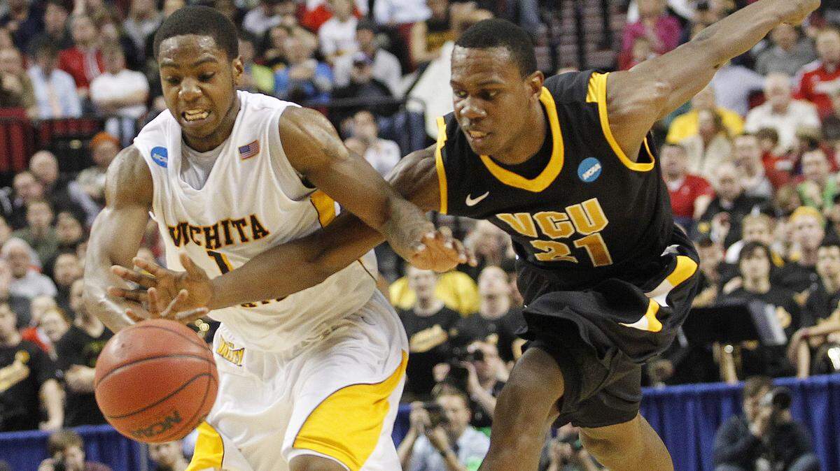 Wichita State’s Joe Ragland scrambles for a loose ball against VCU’s Treveon Graham during their NCAA tournament game at the Rose Garden in Portland, Oregon. (March 14, 2012)