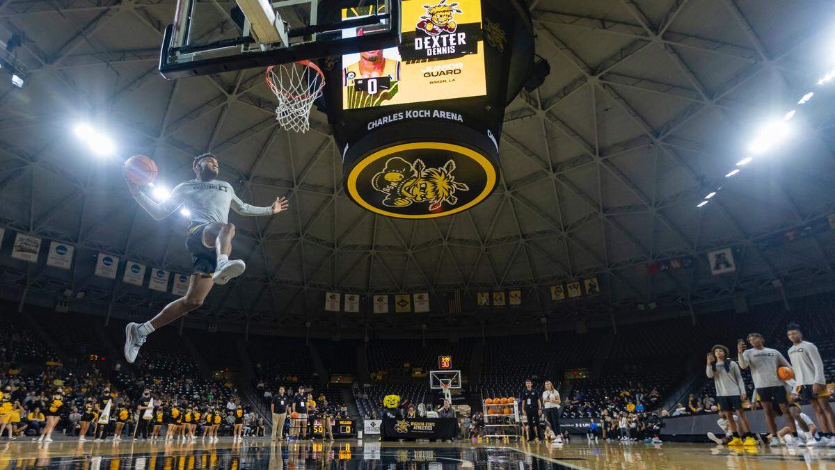 Dexter Dennis soars in for the winning dunk at Shocker Madness at Koch Arena on Tuesday night.