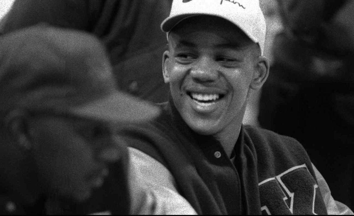 KU senior Steve Woodberry laughs while signing hundreds of autographs in 1992 at the KU alumni and Wichita all stars basketball fundraiser at South High School.