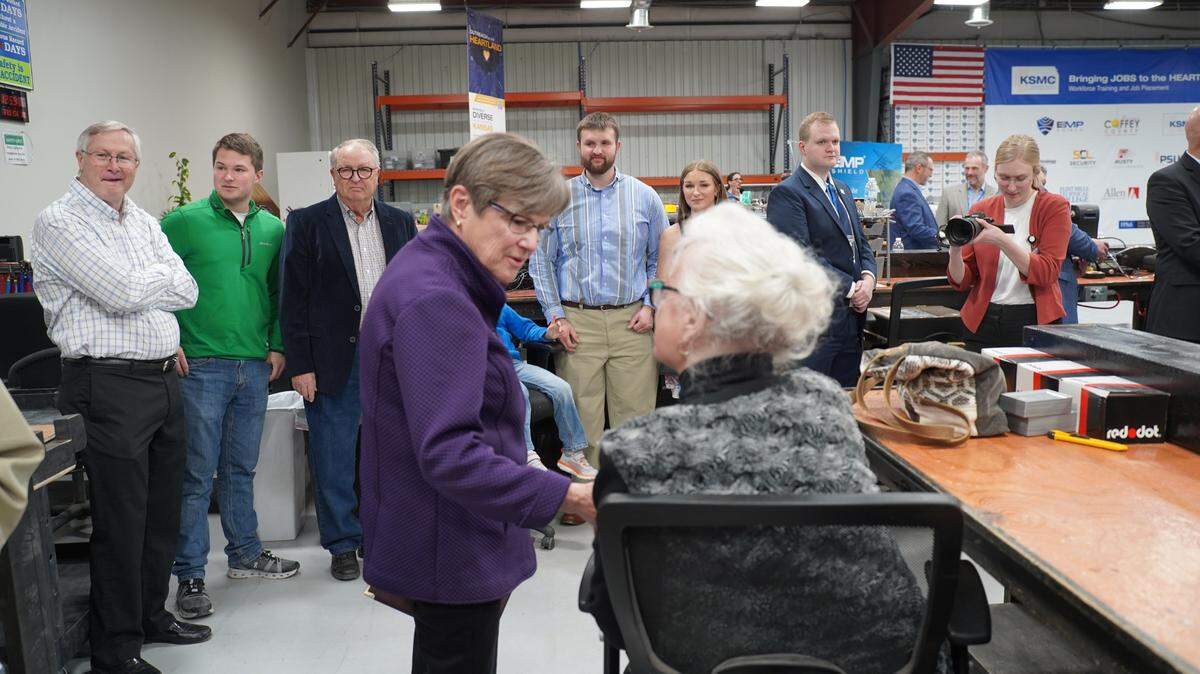 Governor Laura Kelly talks with workers at EMP Shield during the announcement of the company’s plan to build a $1.9 billion facility in Coffey County, Kansas.
