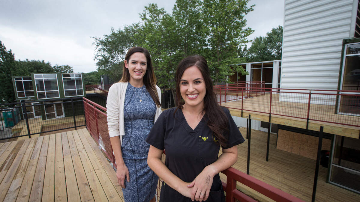 Sisters Krista Racine, left, and Hannah Marko at Revolutsia, a new shipping container development where Racine is a broker and Marko is opening a new charcuterie business called Boards.