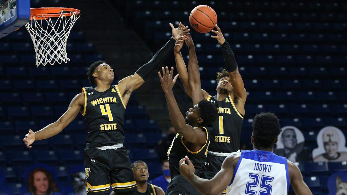 Wichita State freshman Ricky Council IV (left) soars for a rebound in the Shockers’ 69-65 win over Tulsa at the Reynolds Center on Tuesday night.