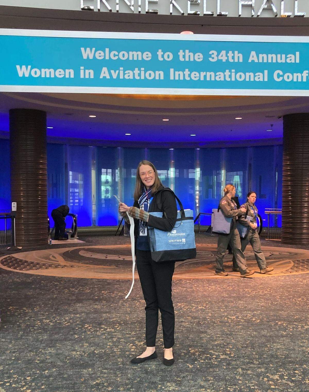 Wichita engineer Kim Burton at the aviation conference with her library short story.