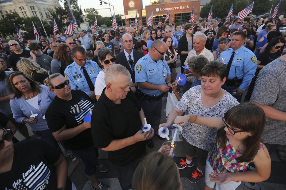 About 500 people gathered at a candlelight vigil for Deputy Robert Kunze III  at the Wichita/Sedgwick Law Enforcement Memorial. Deputy Robert Kunze III was killed on Sunday while responding to a suspicious character call near Wichita.