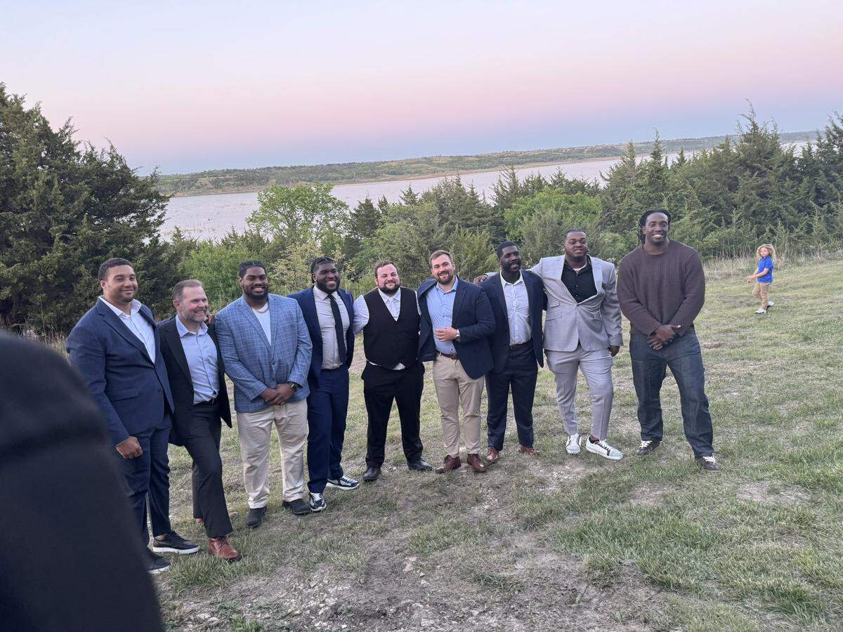 Cooper Beebe poses for a picture with several of his former Kansas State football teammates at his wedding reception.