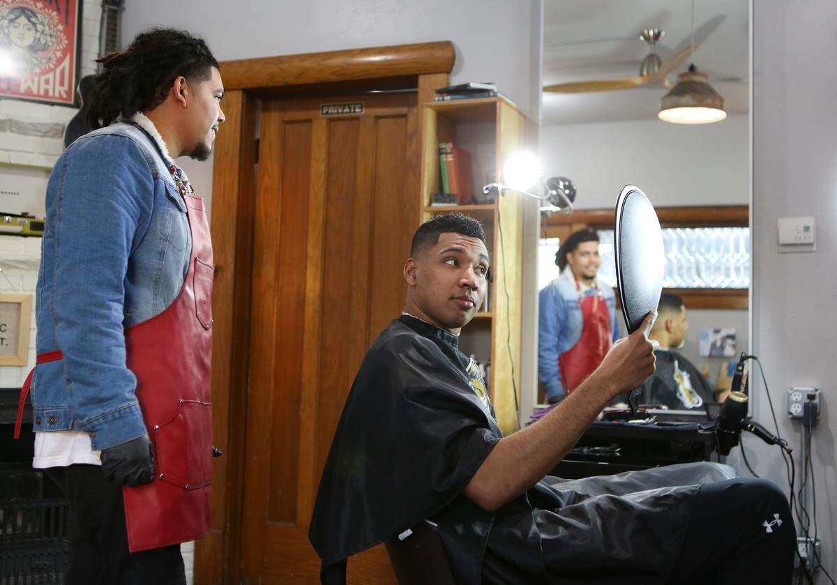 Wichita State basketball player Jaime Echenique’s hair takes a look at the haircut Keyo Sanchez gave him at Tory Brooke Salon. Sanchez has been cutting most of the players’ hair for several years.