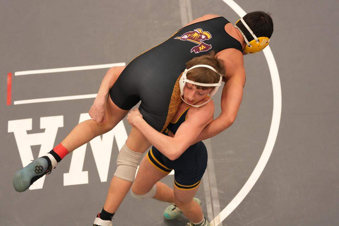 Brayden Richards, Northwest, right beat Ray Pitcher, West, in the 144 pound of the KSHSAA 6A West Regional wrestling tournament at North High School.
