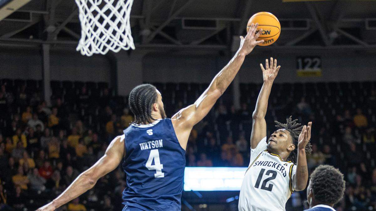 WIchita State’s Melvin Flanagan puts up a floater over Longwood’s Zac Watson to end the first half of their game on Saturday at Koch Arena.