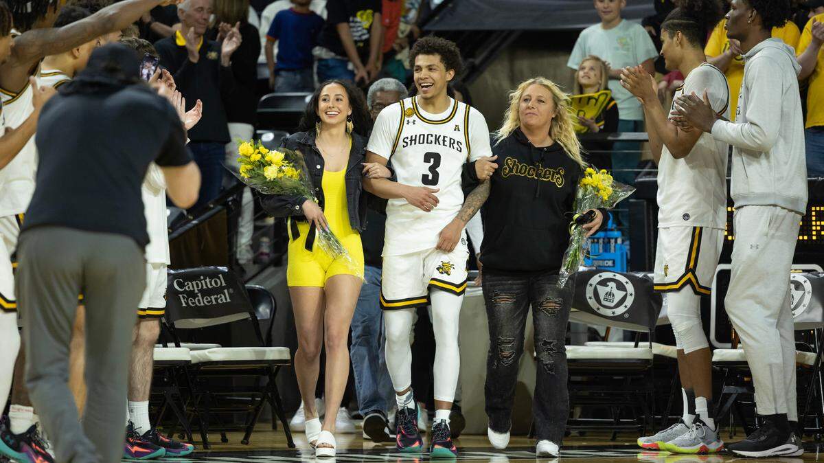 Wichita State senior Craig Porter Jr. celebrates senior day with his family this past season at Koch Arena.