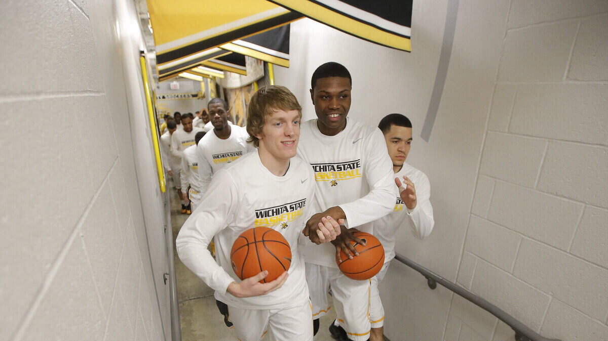 Wichita State’s Ron Baker, left, Cleanthony Early, middle, and Fred VanVleet come out from the locker room before their game against Missouri State at Koch Arena in 2014. Tekele Cotton is behind them.