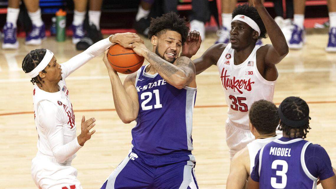 Kansas State’s Davion Bradford (21) drives for the basket against Nebraska’s Alonzo Verge Jr., left, and Eduardo Andre (35) during the second half of an NCAA college basketball game Sunday, Dec. 19, 2021, in Lincoln, Neb. (AP Photo/Rebecca S. Gratz)