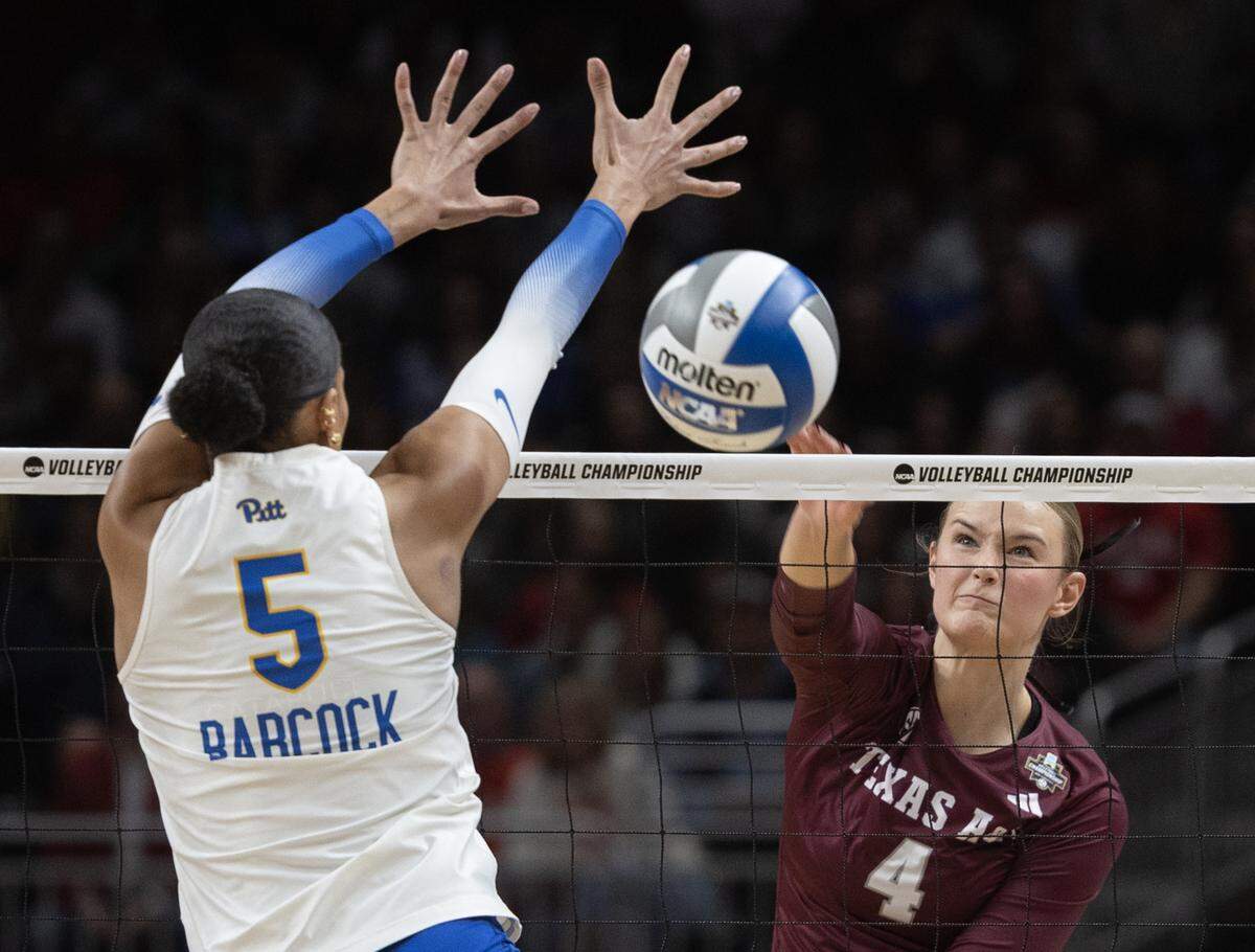 Texas A&M’s Emily Hellmuth tries to a shot past Pittsburgh’s Olivia Babcock during their semifinal match of the NCAA Volleyball Championship on Thursday night at the T-Mobile Center.