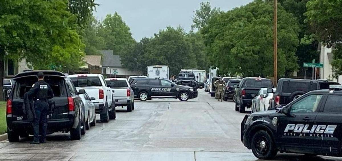 Officers in tactical gear and a SWAT vehicle at 119th and Binter in west Wichita, near where law enforcement killed 39-year-old Gregorio Merced Banuelos after a multi-hour standoff on May 25, 2022.