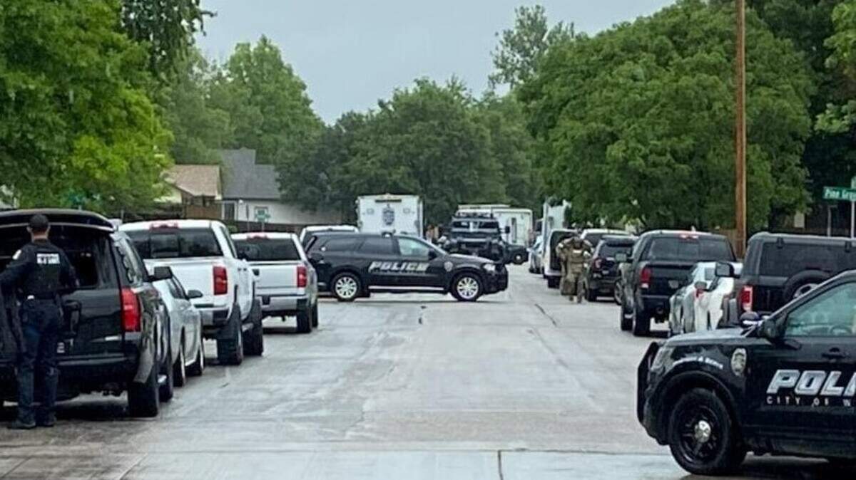 Officers in tactical gear and a SWAT vehicle can be seen Wednesday afternoon at 119th and Binter, near where police had been involved in a standoff since around 1:30 a.m.