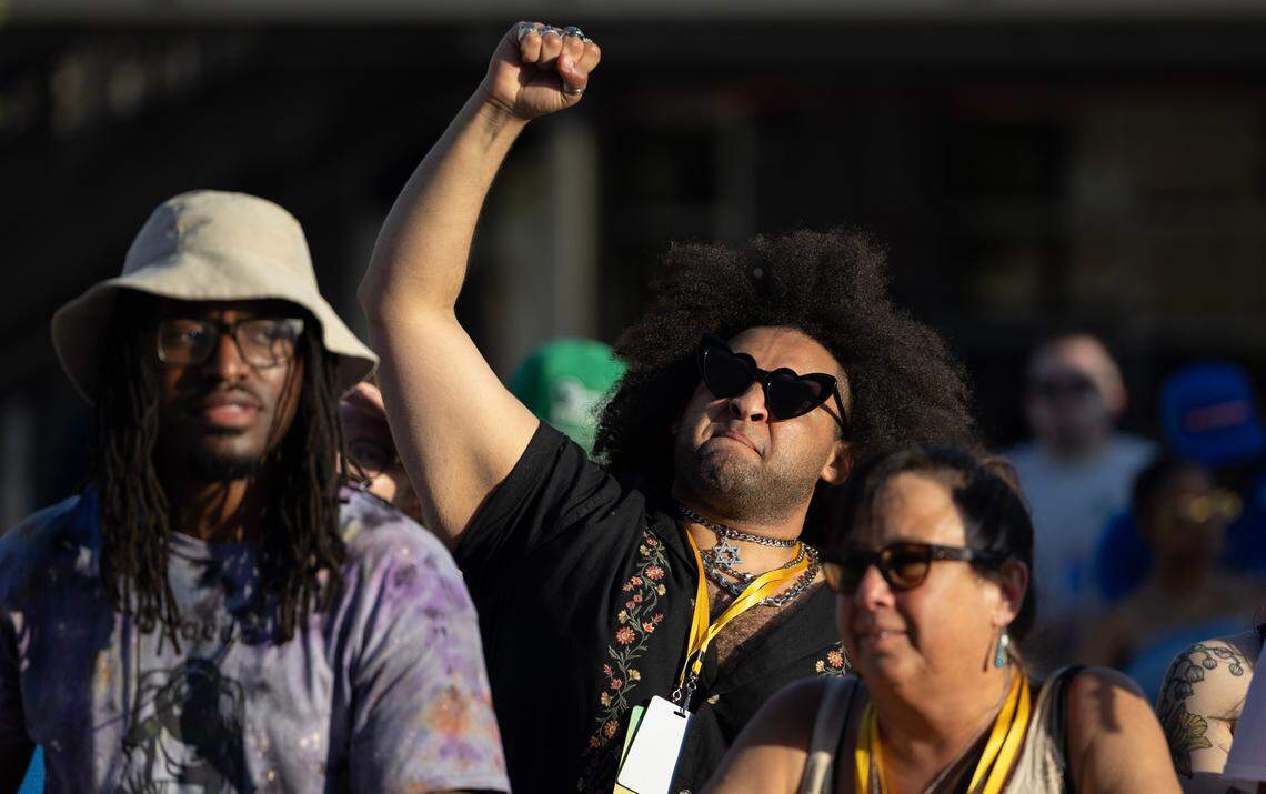 A fan pumps his fist in the air during a set by rapper D Smoke during Elsewhere Fest on Friday.
