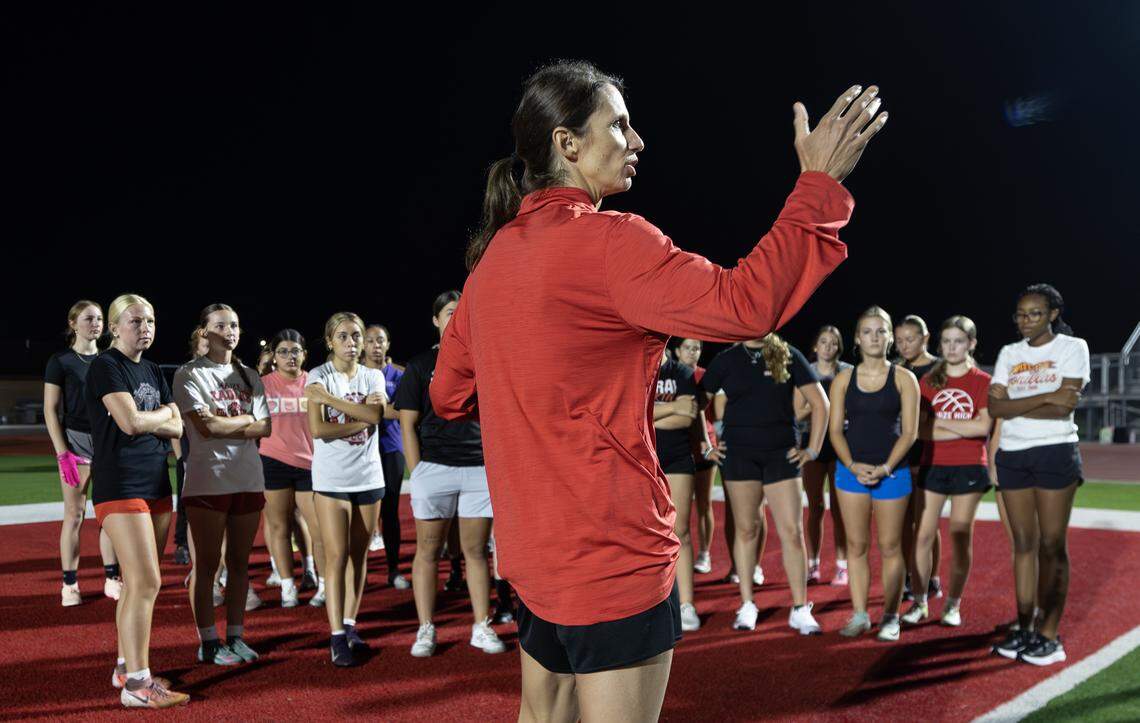 Shelby Hillman, the head coach of the new Maize High flag football team, gives instructions of the girls at the start of their first practice on Wednesday morning.