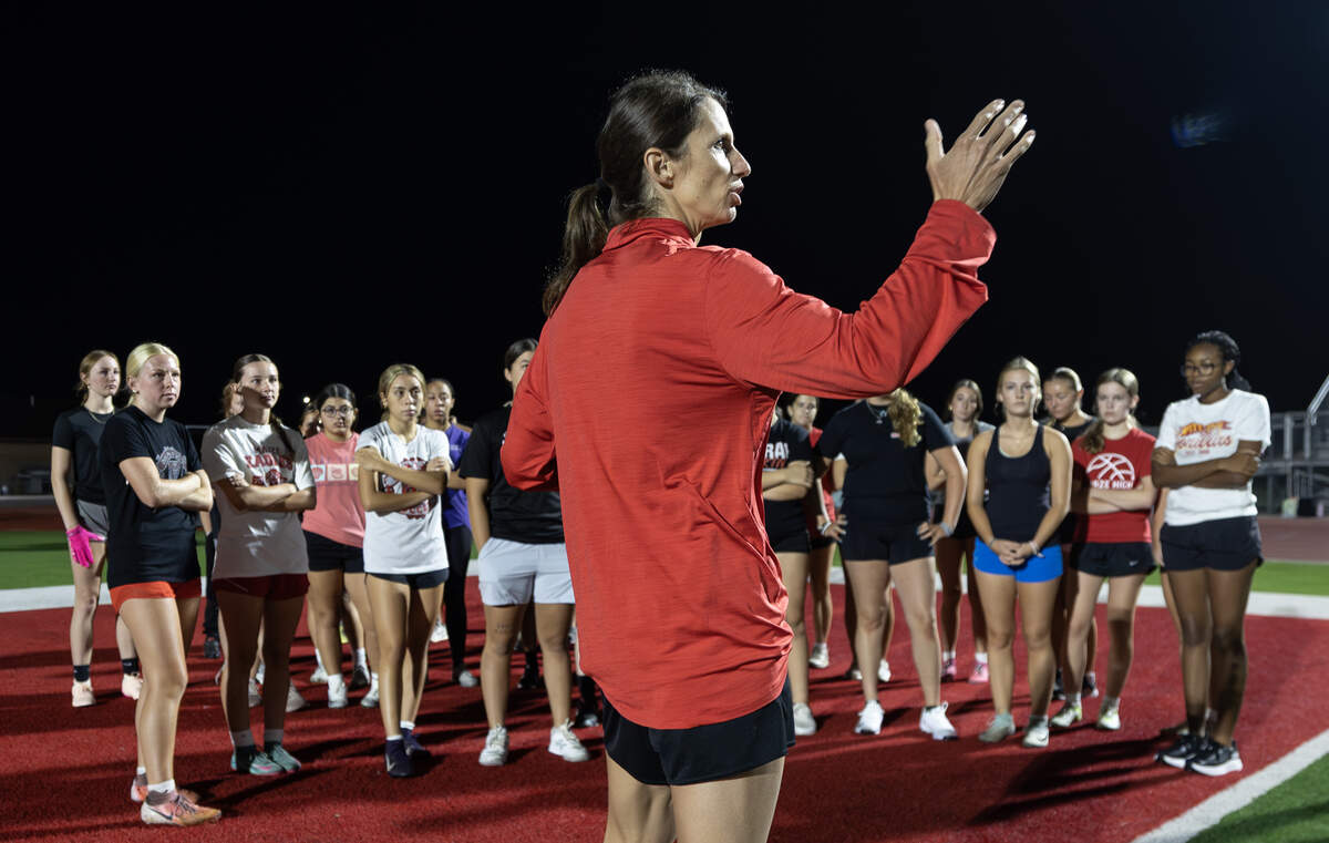 Shelby Hillman, the head coach of the new Maize High flag football team, gives instructions of the girls at the start of their first practice in August.