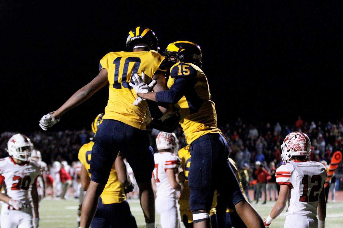 Wichita Northwest junior receiver Zion Jones (15) celebrates with senior receiver Jamir Cupps after scoring his game-winning touchdown in the Grizzlies’ 67-60 state semifinal win over Maize on Friday night. (Nov. 16, 2018)
