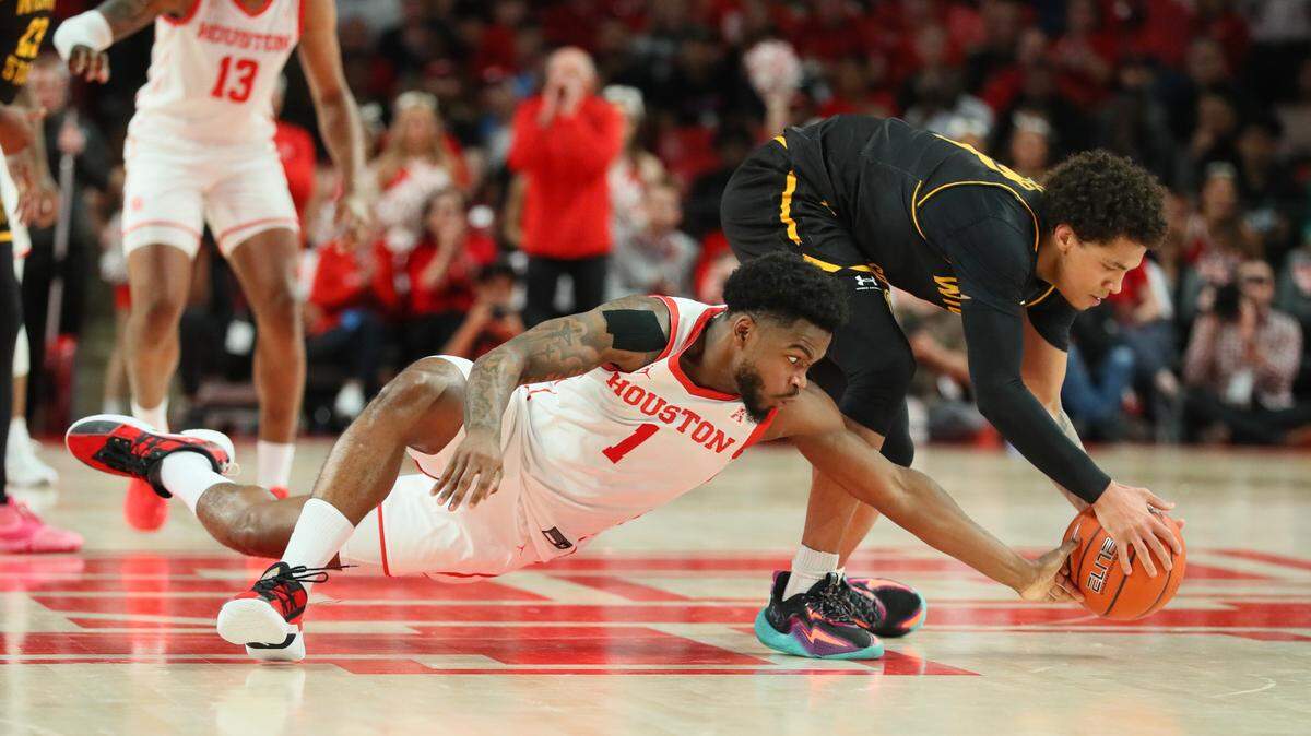 Houston’s Jamal Shead dives for a loose ball against Wichita State’s Craig Porter in the Cougars’ 83-66 win at the Fertitta Center on Thursday.