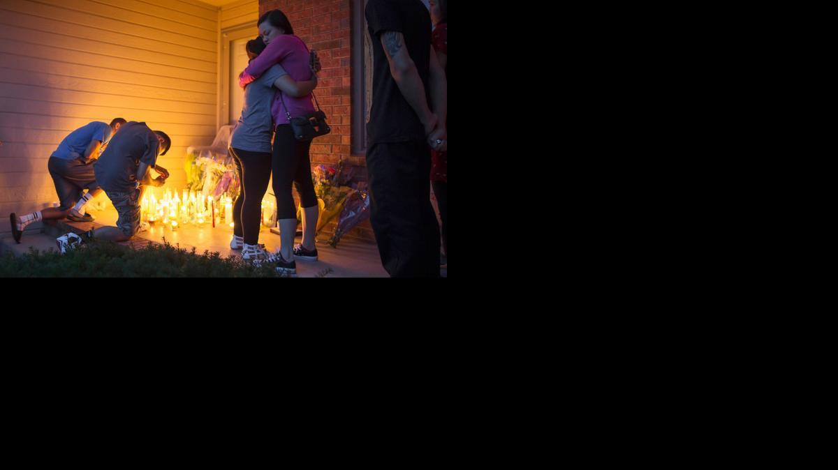 Friends and family members light candles during a vigil for Trinh Pham, Sean Pham and Tuyet Huynh on Thursday night. 

