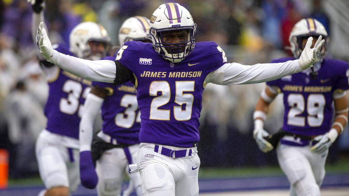 James Madison linebacker Jailin Walker (25) celebrates after returning an interception for a touchdown during the first half of an NCAA football game against Texas State in Harrisonburg, Va., Saturday, Oct. 1, 2022. (Daniel Lin/Daily News-Record Via AP)