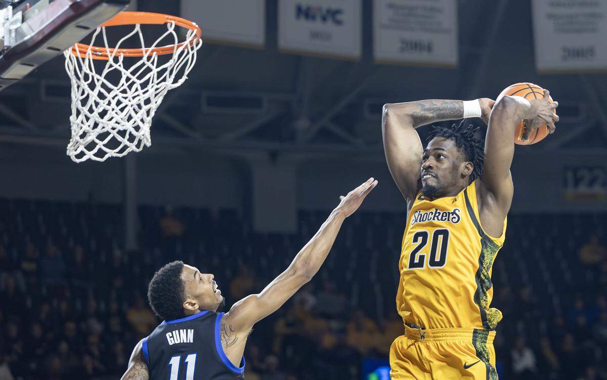 Wichita State’s Emmanuel Okorafor dunks the ball over DePaul’s CJ Gunn during the first half of their game on Saturday at Koch Arena.