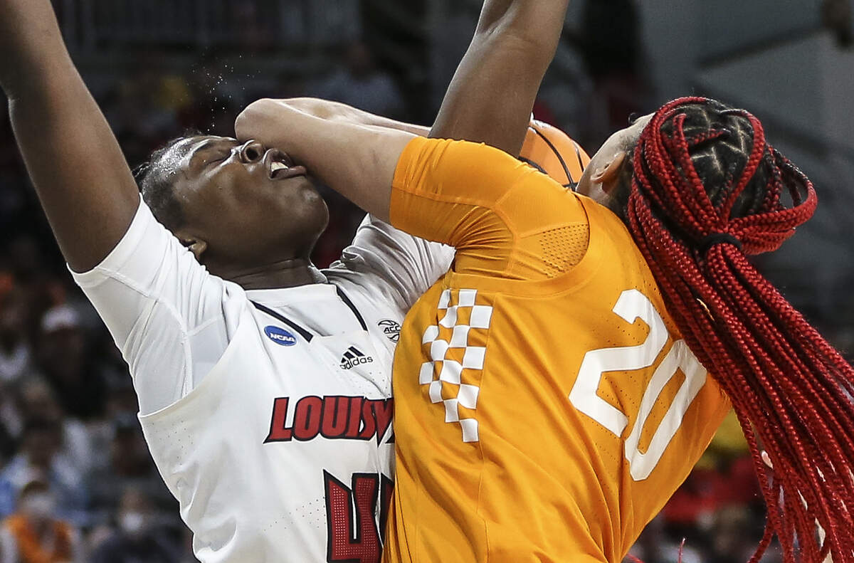 Louisville’s Olivia Cochran takes an elbow to the face from Tennessee’s Tamari Key during the fourth quarter of their Sweet 16 game last spring in Wichita.