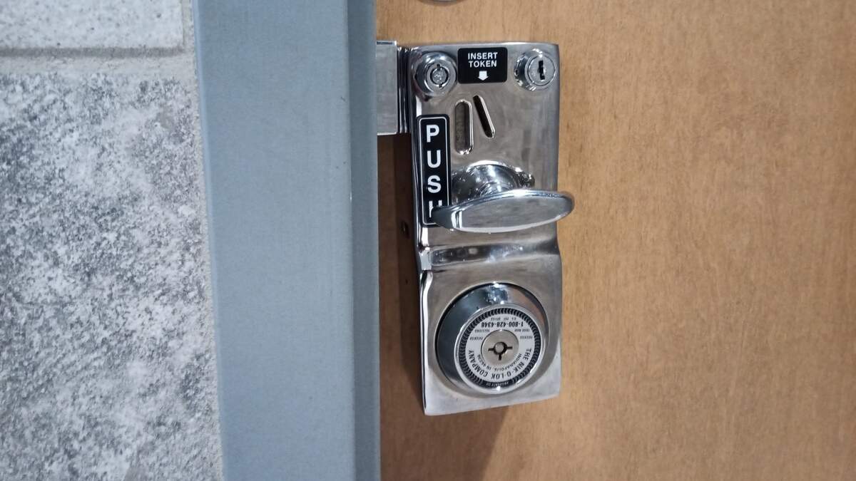 Coin locks like this essentially vanished from American restrooms in the 1970s, but are making a comeback at the Wichita downtown library, where you need to get a free token from a service desk to access family restrooms.