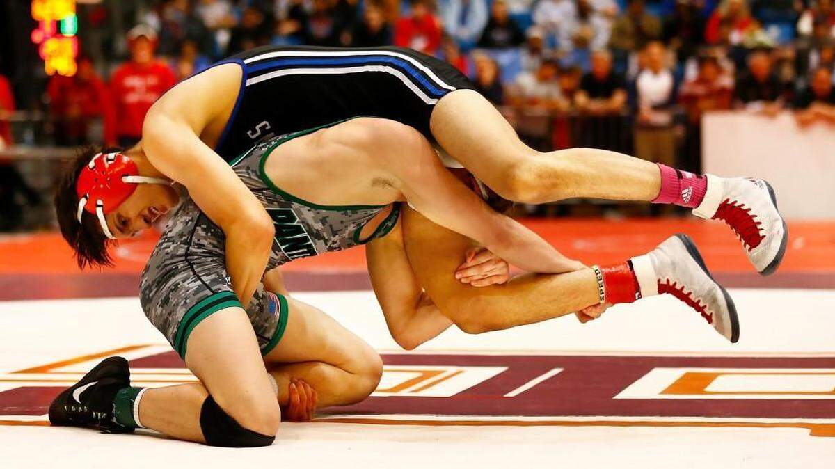 Derby’s Cade Lindsey (bottom) is ranked No. 1 the 170-pound weight class in Class 6A.