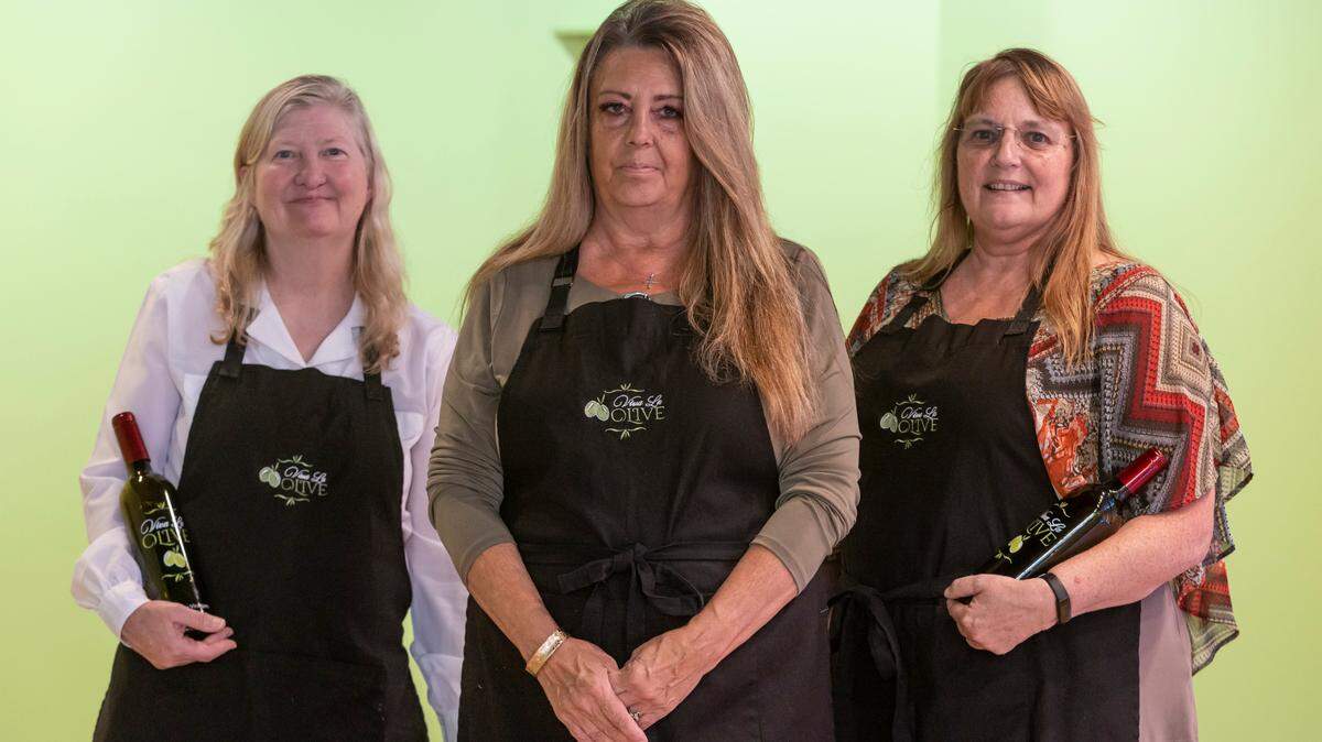 Diana Meyer, left, and Cindy Fortune, right, were skeptical when their friend Kim Miller, middle, wanted to take them in an olive oil and vinegar store in Ohio, but they loved it so much, they’re now starting their own. Viva La Olive will open in Old Town Square in October.