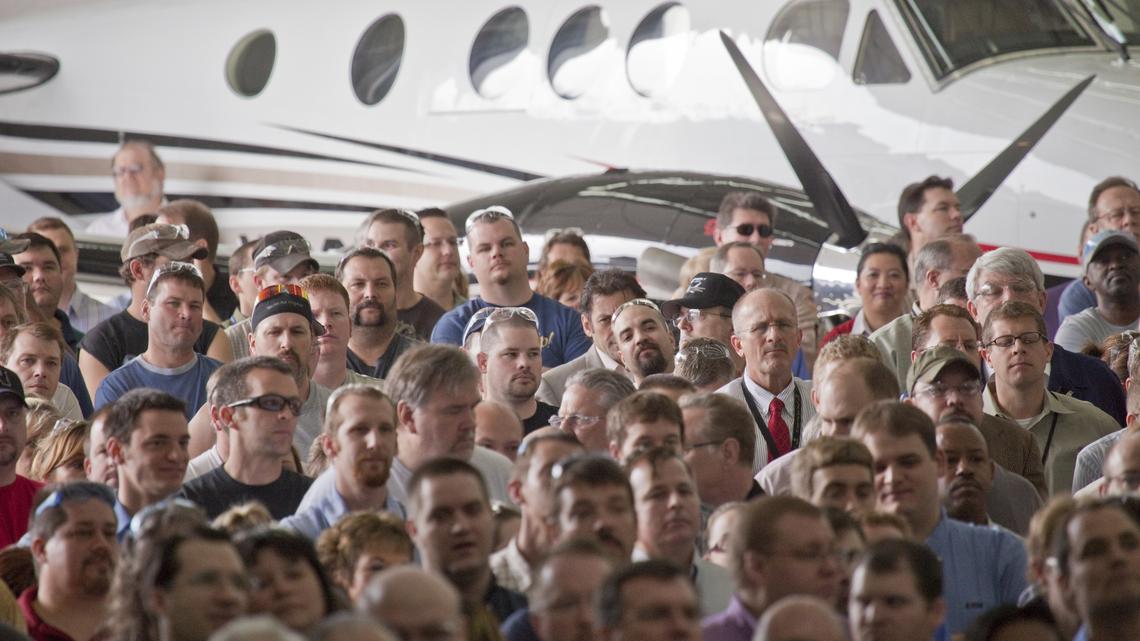 General aviation workers listen during a rally at Cessna Aircraft in Wichita in 2011.