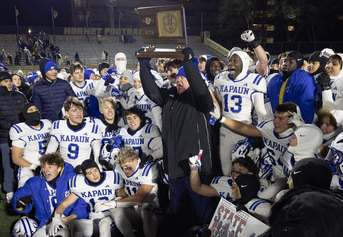 Kapaun head coach hoists the state championship trophy on Saturday after leading the Crusaders to the 4A state title. This was Schartz’s first state championship in nearly 40 years of coaching. Kapaun defeated Bishop Miege 56-21.