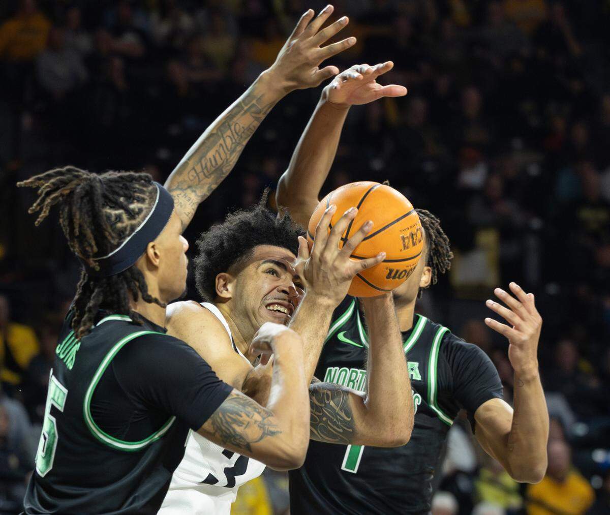 Wichita State’s Ronnie DeGray III struggles to find room to the basket between North Texas defenders 	Rubin Jones, left, and Aaron Scott during the first half of their game at Koch Arena on Thursday night. 