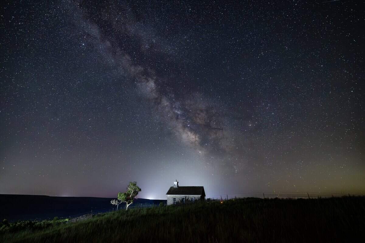 The Milky Way galaxy can be seen in the southern sky from the Lower Fox Creek Schoolhouse at the Tallgrass Prairie Preserve on Tuesday night. The galaxy is best viewed away from city lights in the summer, when the earth's orbital position faces the galaxy's star-filled core.