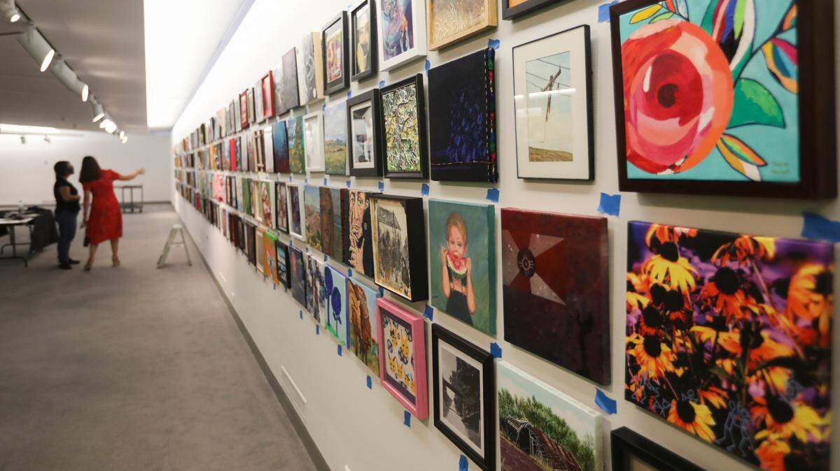 “Foot in the Door” exhibition runs through April 18, 2021 displaying work by 570 Wichita artist. Each artist was limited to one piece that had to be hangable and 12 inches by 12 inches. Entries came from professional artists and those still in elementary school. (October 7, 2020)