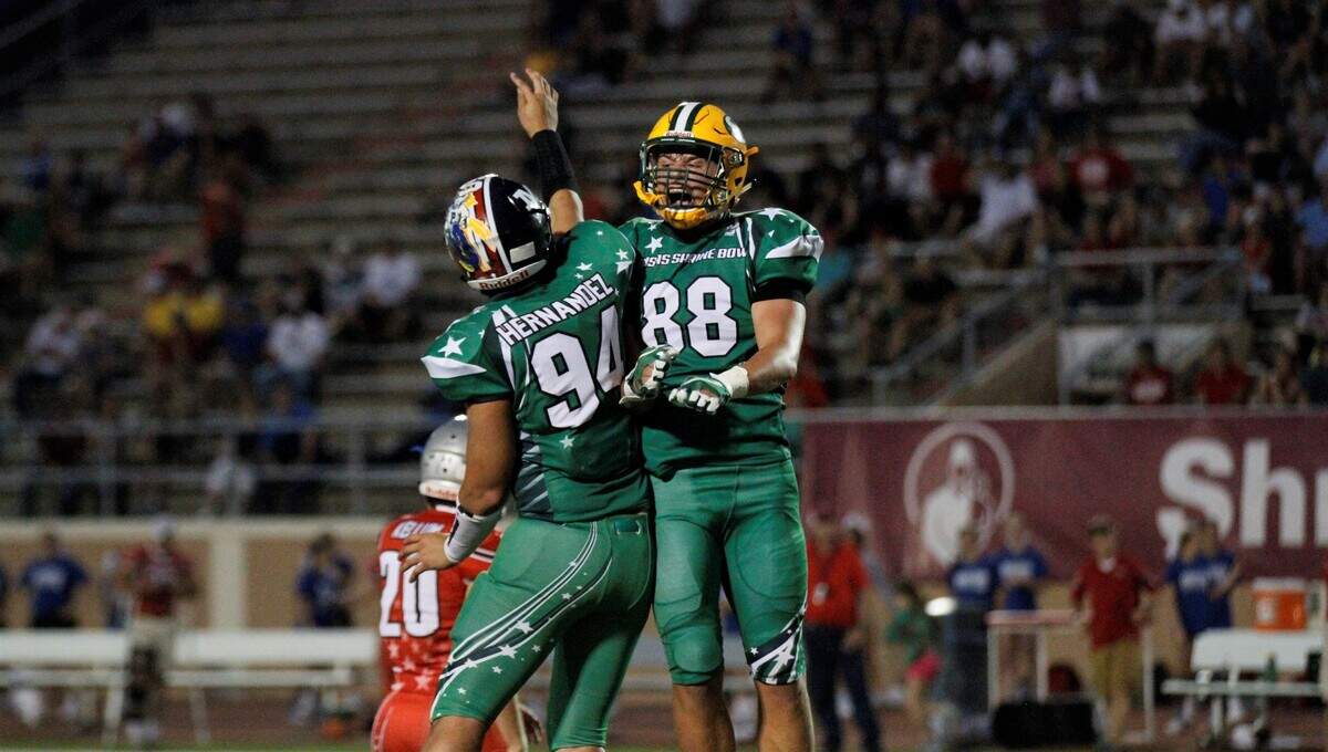 West defensive linemen Isaac Mitchell (Salina South) and David Hernandez (Manhattan) celebrate an interception.
