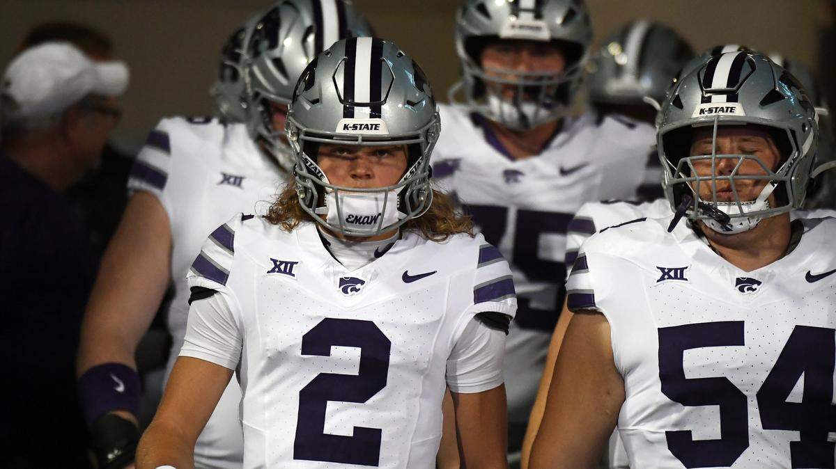 Kansas State Wildcats quarterback Avery Johnson (2) leads players onto the field before the game against the Colorado Buffaloes at Folsom Field.
