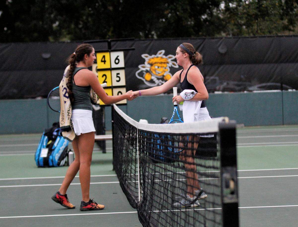 Carroll’s Brittany Steven (left) and Kapaun’s Clara Whitaker (right) shake hands after their City League singles championship match Saturday. (Sept. 29, 2018)